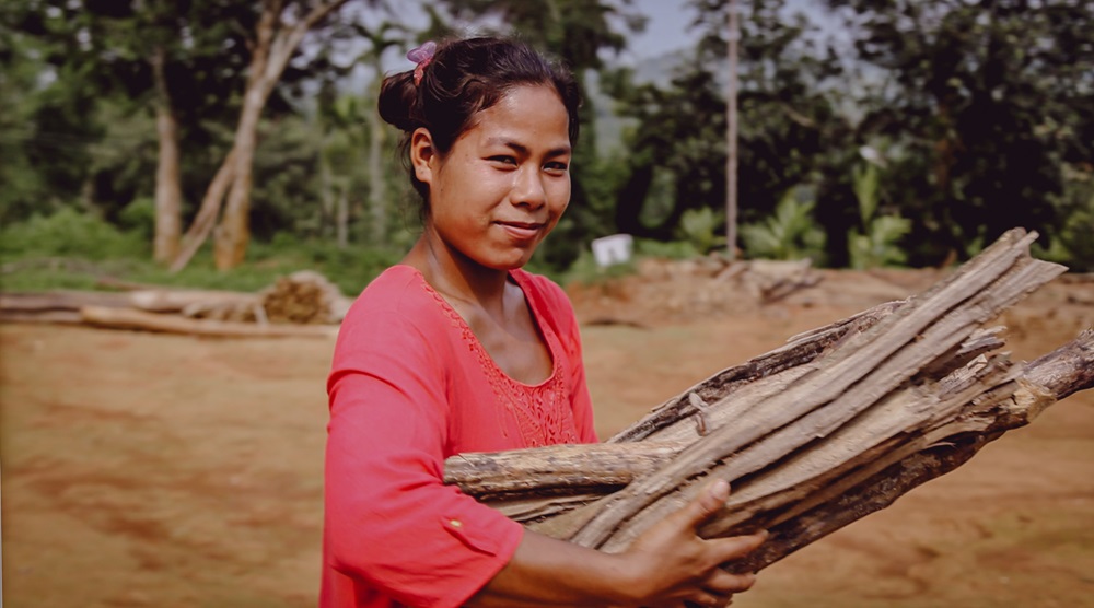 woman carrying wood
