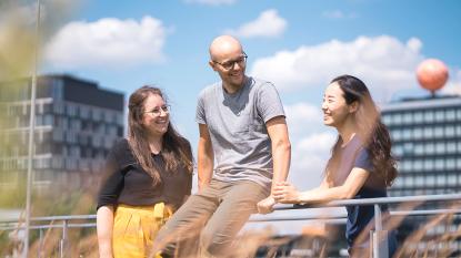 three people sitting in the sun